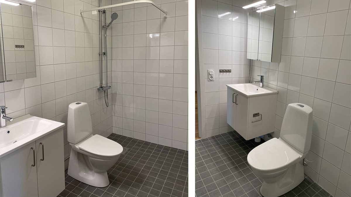 Badrum med vitt kakel och grått klinker