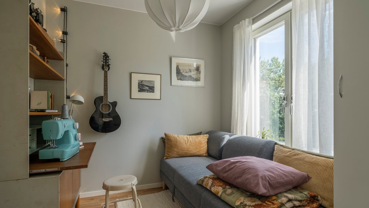 Rum med soffa, symaskin och gitarr